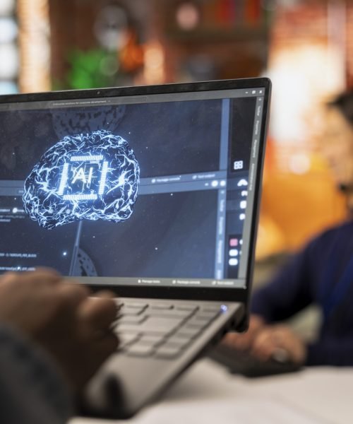 Call center worker uses AI technology on laptop to provide quick replies to common customer queries, close up. Customer service agent generates automated responses to clients using AI tech on notebook